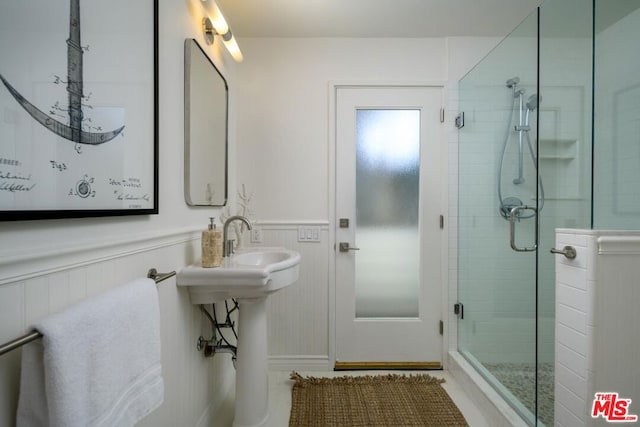 bathroom featuring a shower with door