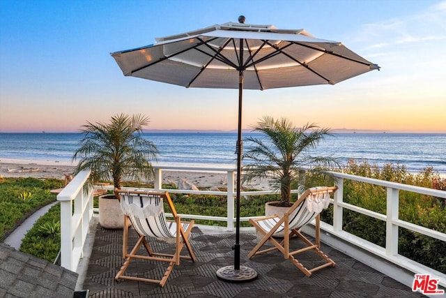 exterior space with a water view and a view of the beach