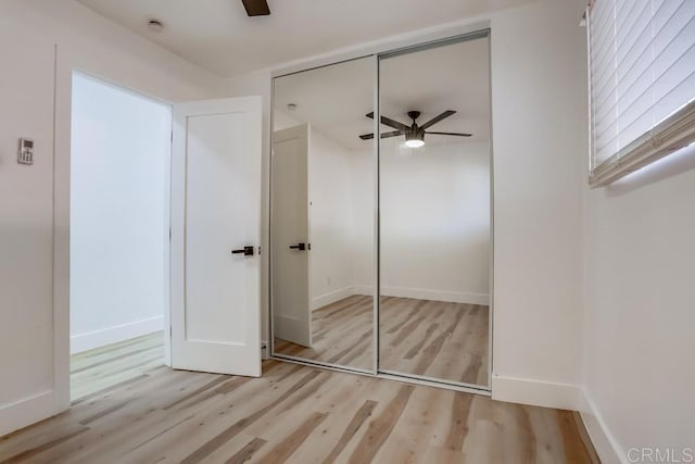 unfurnished bedroom featuring a closet, ceiling fan, and light hardwood / wood-style flooring