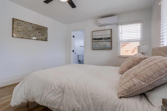 bedroom with wood-type flooring, a wall unit AC, and ceiling fan