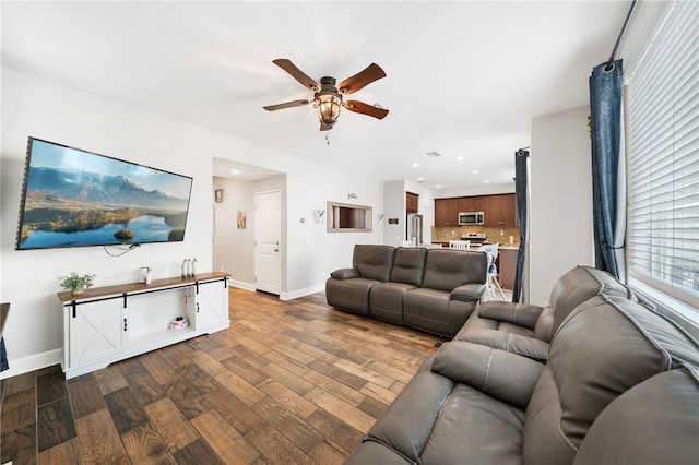 living room with dark hardwood / wood-style floors and ceiling fan