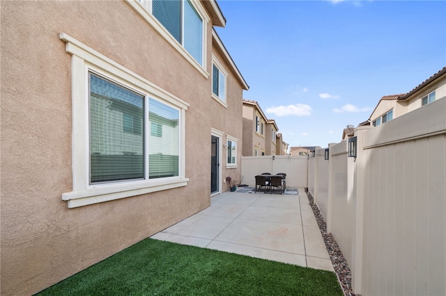 view of side of property featuring a patio