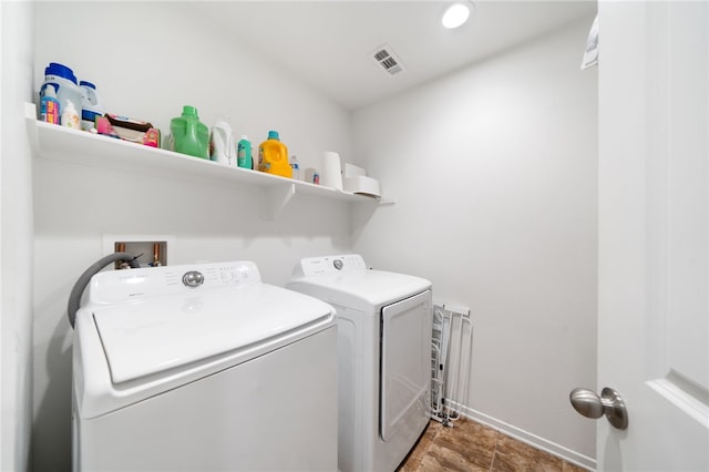 clothes washing area featuring washer and clothes dryer