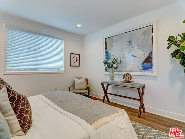 bedroom with hardwood / wood-style flooring