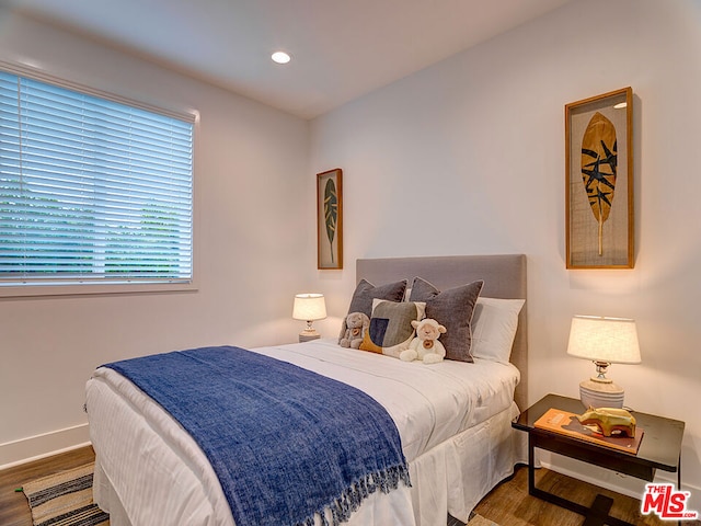 bedroom with hardwood / wood-style floors