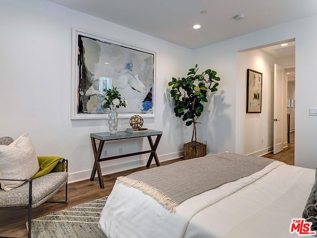 bedroom with dark hardwood / wood-style flooring