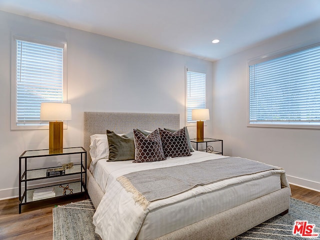 bedroom featuring hardwood / wood-style flooring and multiple windows