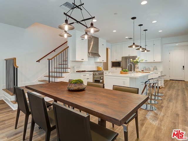 dining space with light hardwood / wood-style floors