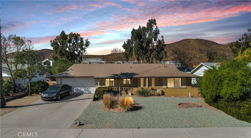 ranch-style house with a mountain view and a garage