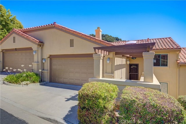 6279 Twinberry Cir Unit 7, Avila Beach, CA 93424 - mediterranean / spanish-style house with stucco siding, an attached garage, concrete driveway, a tiled roof, and a chimney