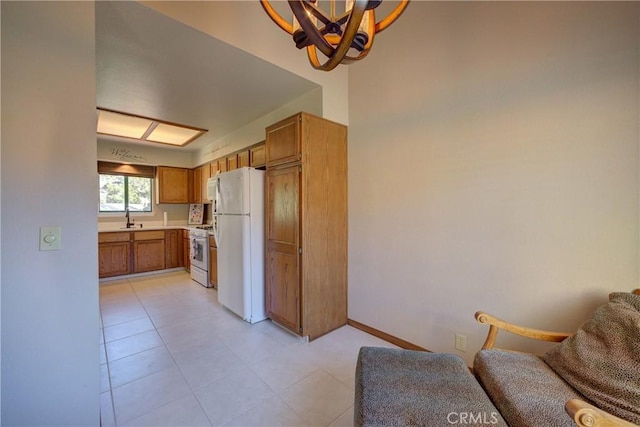 6279 Twinberry Cir Unit 7, Avila Beach, CA 93424 - kitchen with white appliances, light countertops, open floor plan, brown cabinetry, and a chandelier