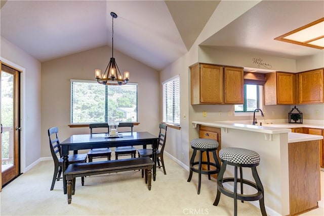 6279 Twinberry Cir Unit 7, Avila Beach, CA 93424 - kitchen featuring brown cabinets, light countertops, decorative light fixtures, vaulted ceiling, and a peninsula