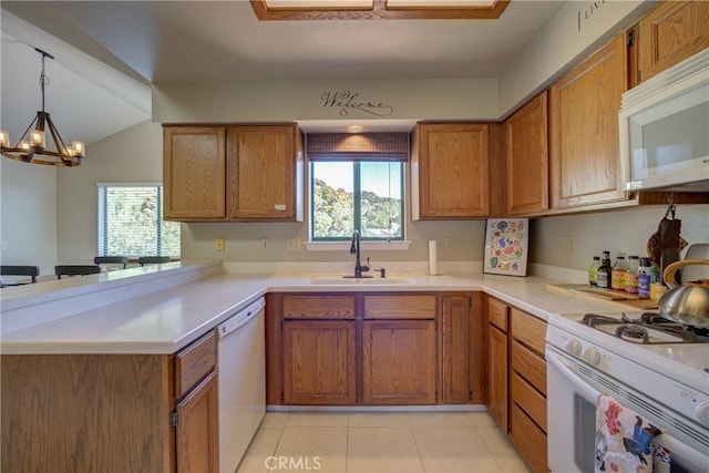 6279 Twinberry Cir Unit 7, Avila Beach, CA 93424 - kitchen with white appliances, brown cabinets, a peninsula, and healthy amount of natural light