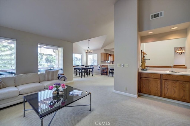 6279 Twinberry Cir Unit 7, Avila Beach, CA 93424 - living area featuring a chandelier, light colored carpet, and vaulted ceiling