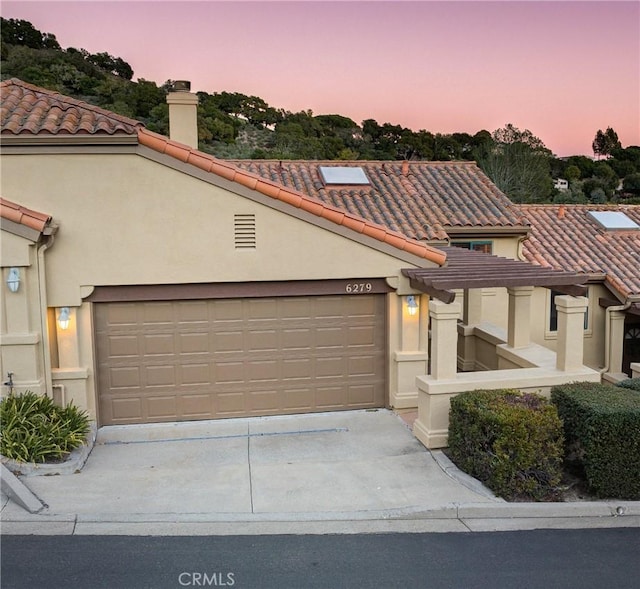 6279 Twinberry Cir Unit 7, Avila Beach, CA 93424 - mediterranean / spanish-style home featuring a tiled roof, stucco siding, a chimney, and concrete driveway