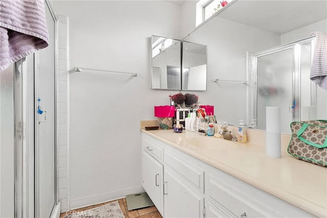 full bathroom featuring a shower stall, vanity, and baseboards