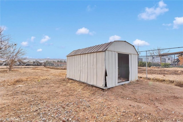 view of shed featuring fence