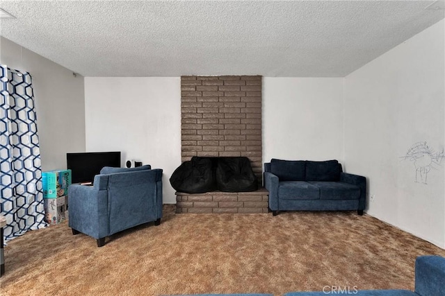 living area featuring carpet floors, a fireplace, and a textured ceiling