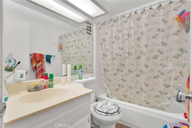 bathroom with toilet, shower / bathtub combination with curtain, and vanity