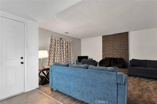 carpeted living room with visible vents and a textured ceiling