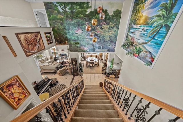 stairway featuring tile patterned floors and a fireplace