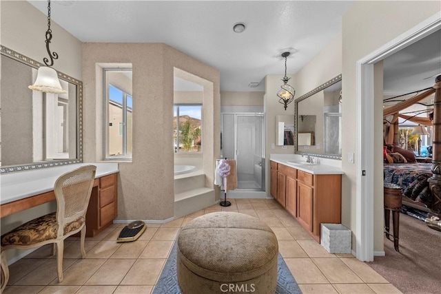 bathroom featuring tile patterned flooring, vanity, and shower with separate bathtub