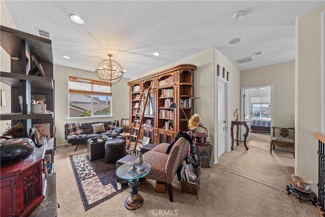 living room with carpet, a wealth of natural light, and an inviting chandelier