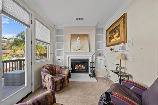 living area with crown molding, built in shelves, and carpet floors