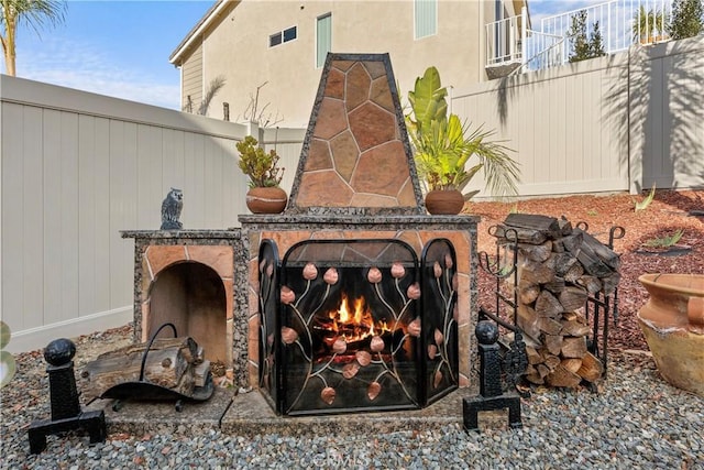 exterior details featuring an outdoor stone fireplace