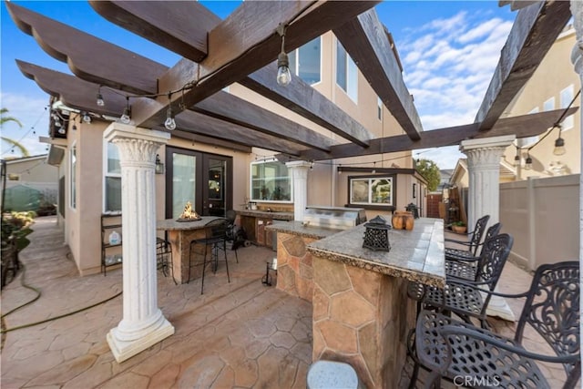 view of patio with an outdoor bar and a pergola