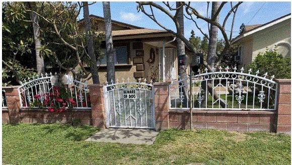 view of gate with a yard