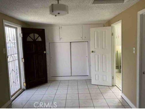 entryway featuring a textured ceiling and light tile patterned flooring