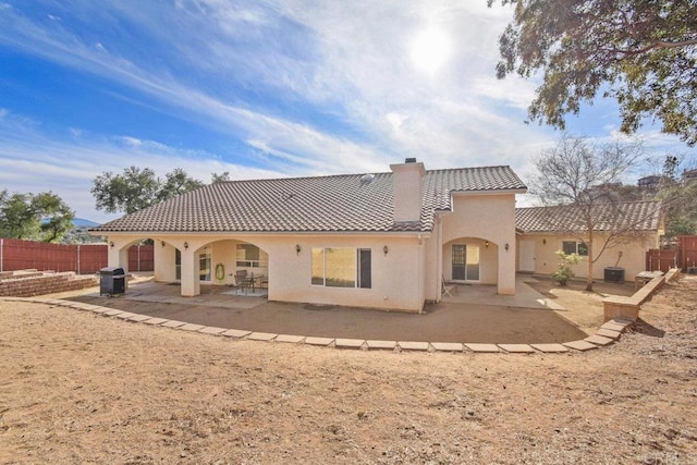 rear view of property featuring a patio