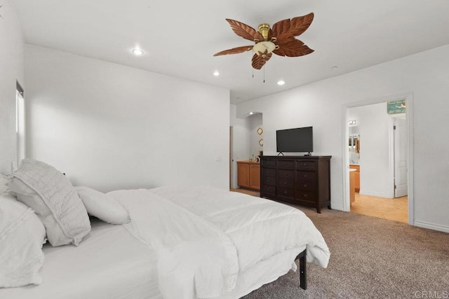 carpeted bedroom featuring ceiling fan and ensuite bathroom