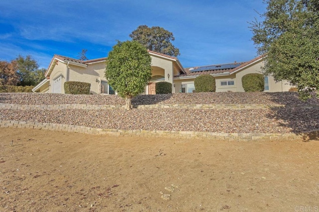 view of front of house with solar panels