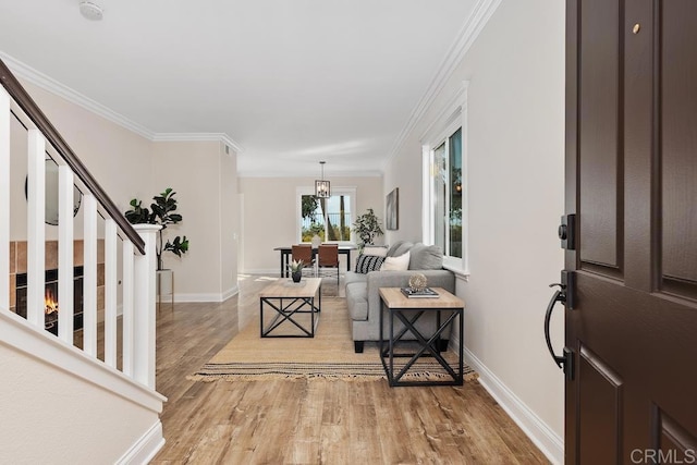 entryway with light hardwood / wood-style flooring and crown molding