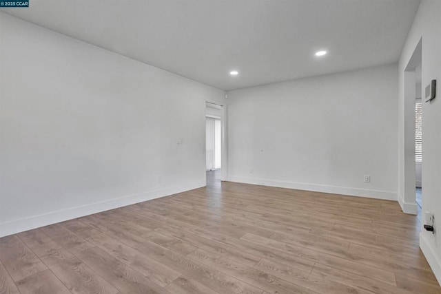 spare room featuring light hardwood / wood-style flooring