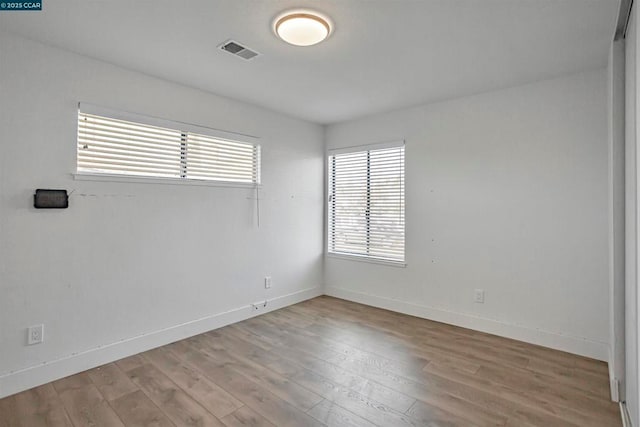 spare room with light hardwood / wood-style floors