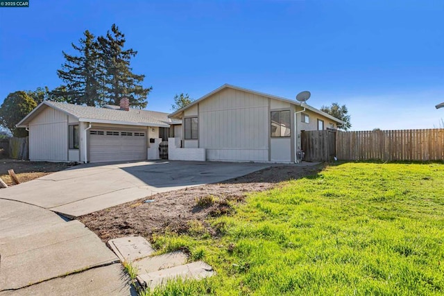 view of front of house featuring a garage and a front lawn