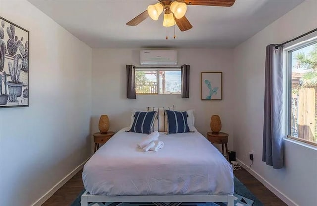 bedroom with ceiling fan, a wall mounted AC, and dark hardwood / wood-style floors