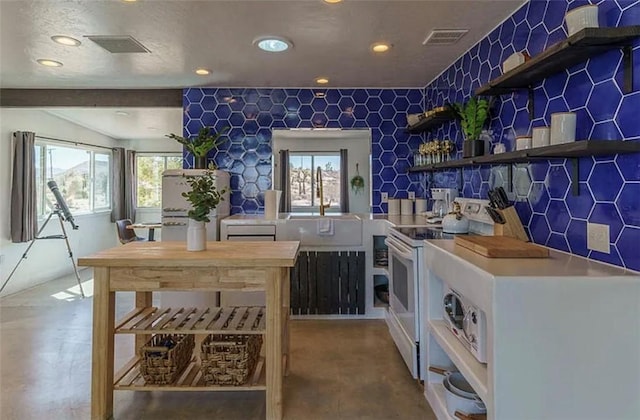 interior space with decorative backsplash, beam ceiling, and white electric range