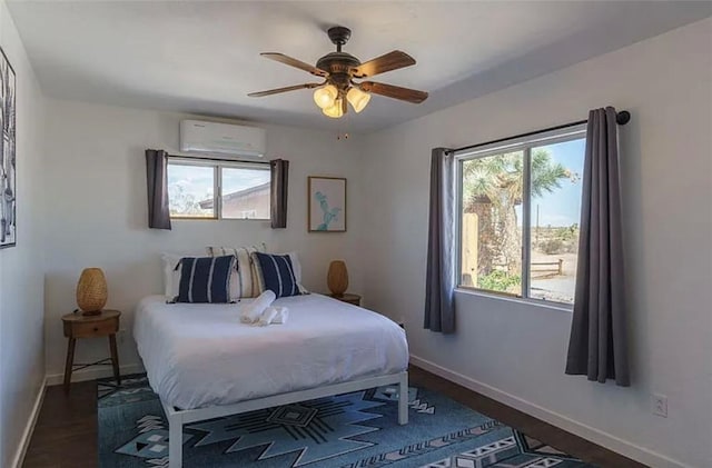 bedroom featuring ceiling fan, an AC wall unit, and multiple windows