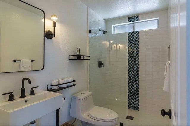 bathroom with sink, toilet, and walk in shower