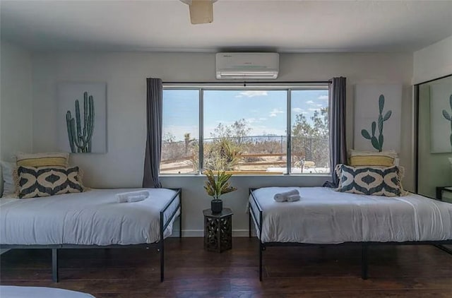 bedroom with multiple windows, a wall mounted AC, ceiling fan, and dark hardwood / wood-style flooring