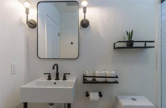 bathroom featuring sink and toilet