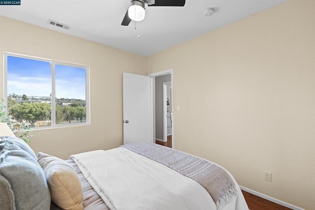 bedroom with dark hardwood / wood-style floors and ceiling fan