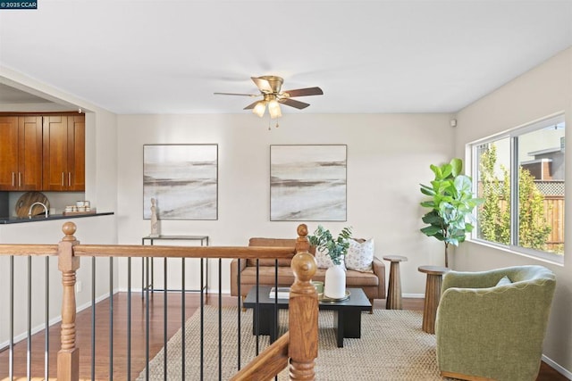 living area featuring ceiling fan