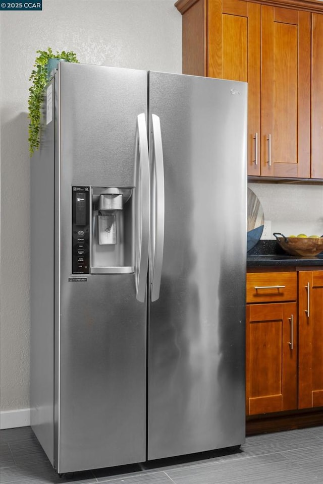 kitchen featuring stainless steel fridge with ice dispenser