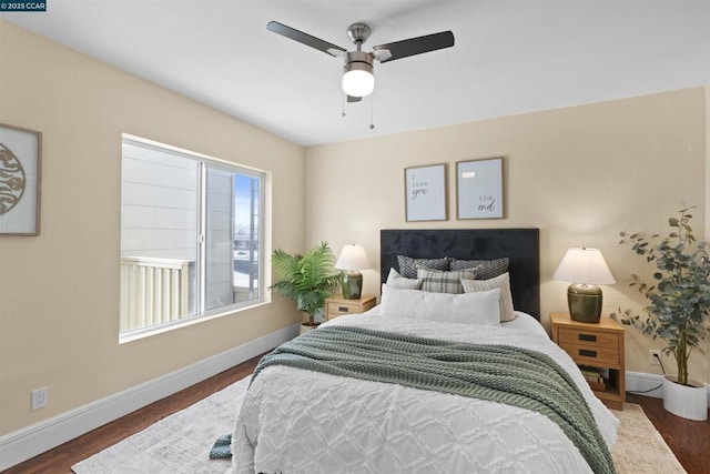 bedroom with dark hardwood / wood-style floors and ceiling fan