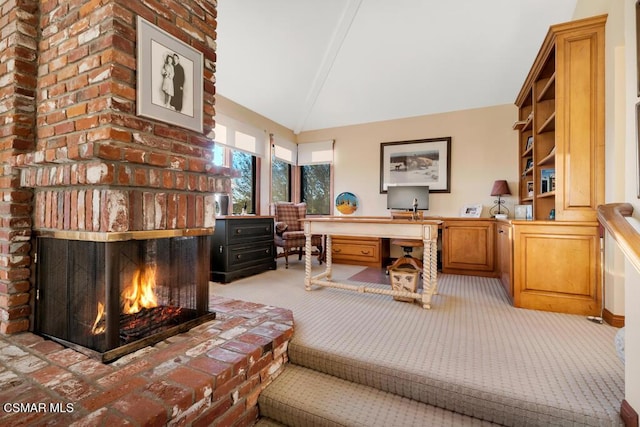 carpeted office with lofted ceiling and a brick fireplace